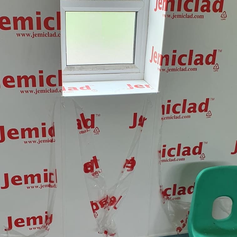 A PVC Walled Space With a Small Window Slot