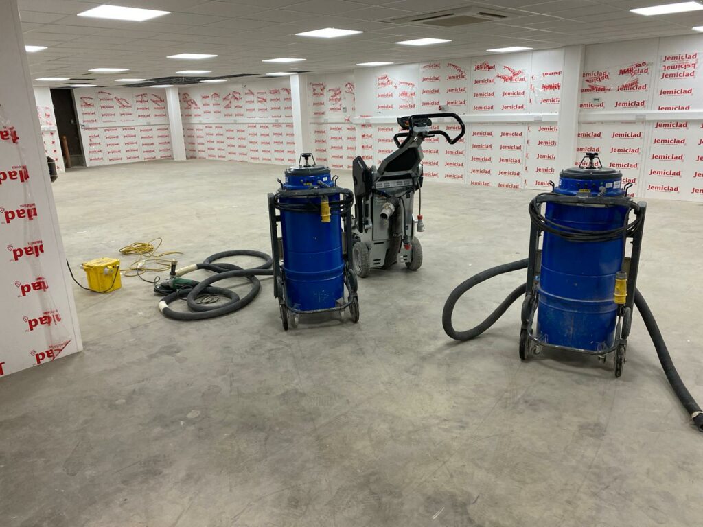 Machines in Blue Placed in an Empty Floor Space