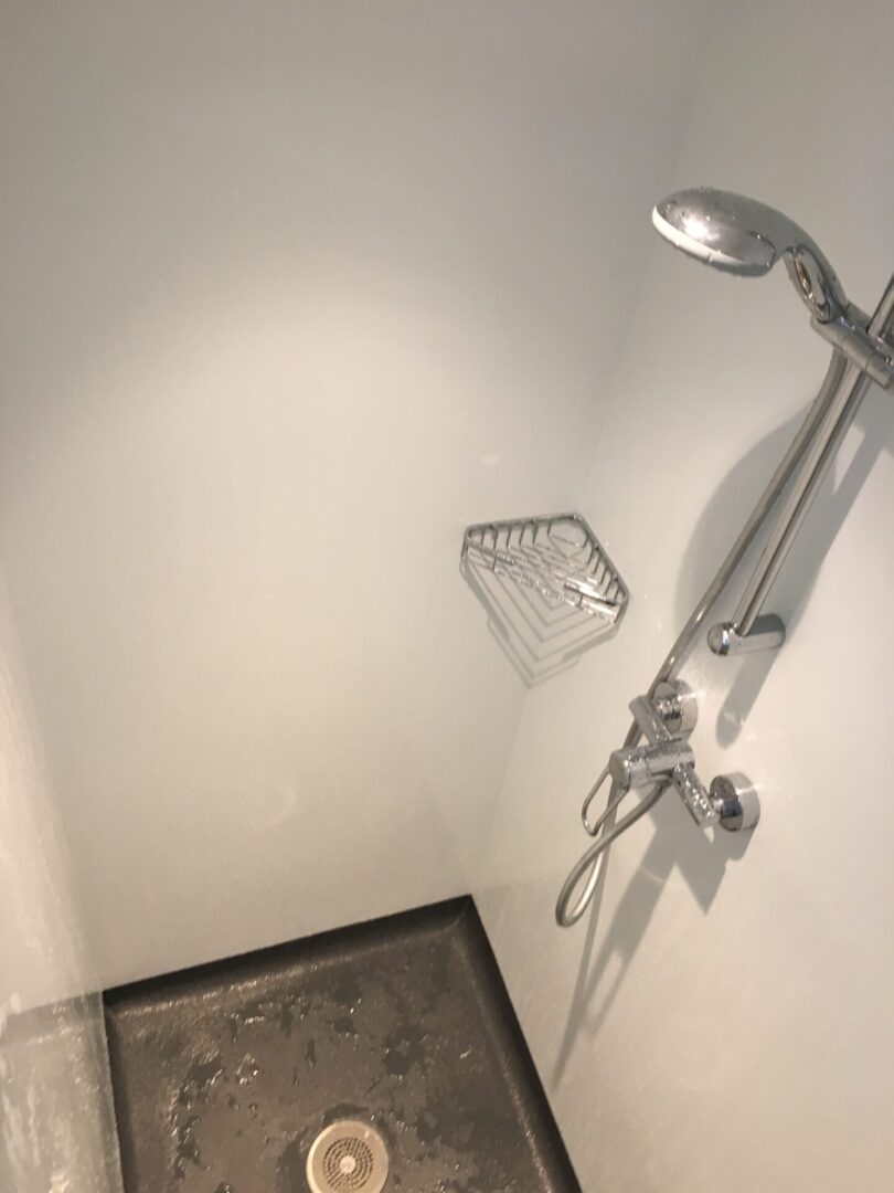 A Hand Shower Space With a Drain