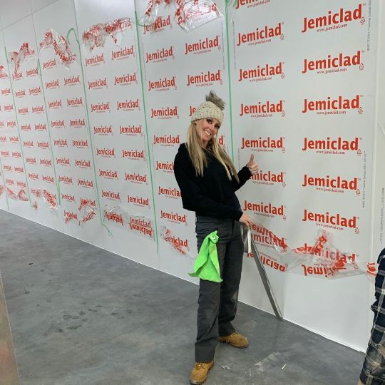A Woman Standing in Front of a PVC Wall